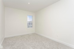 Unfurnished room with baseboards and light colored carpet - 
