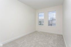 Carpeted spare room with baseboards - 