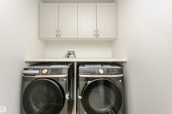 Laundry area featuring cabinet space and independent washer and dryer - 