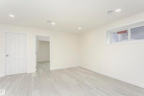 Empty room with light wood-style flooring and recessed lighting - 5111 Kinney Way Sw, Edmonton, AB - Indoor Photo Showing Other Room