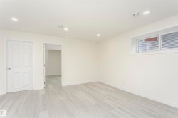 Empty room with light wood-style flooring and recessed lighting - 