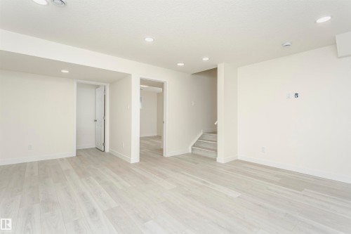 Unfurnished room featuring recessed lighting and light wood-type flooring - 5111 Kinney Way Sw, Edmonton, AB - Indoor