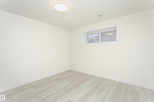 Spare room featuring light wood finished floors and baseboards - 5111 Kinney Way Sw, Edmonton, AB - Indoor Photo Showing Other Room