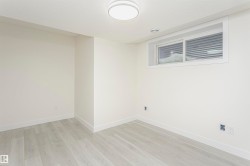 Unfurnished room with light wood finished floors and a textured ceiling - 