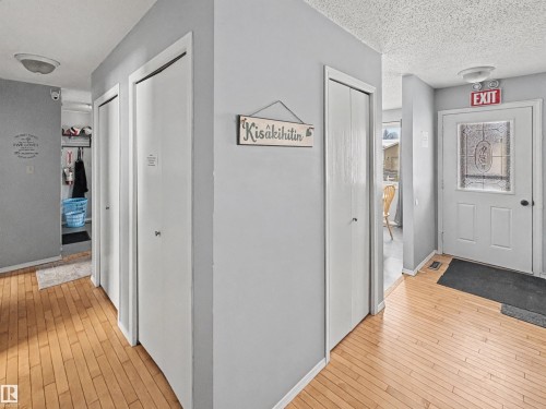 Corridor with light wood-style flooring and a textured ceiling - 4602 42 Avenue, Bonnyville Town, AB - Indoor Photo Showing Other Room