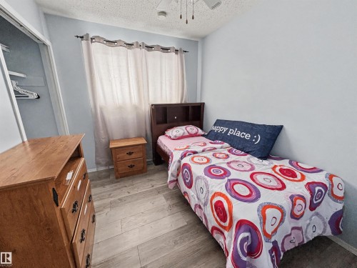 Bedroom featuring light wood-style flooring, ceiling fan, and a textured ceiling - 4602 42 Avenue, Bonnyville Town, AB - Indoor Photo Showing Bedroom