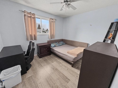 Bedroom with light wood finished floors, a textured ceiling, and a ceiling fan - 4602 42 Avenue, Bonnyville Town, AB - Indoor