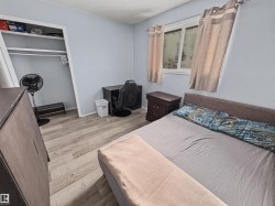 Bedroom with light wood-style floors, a textured ceiling, and a closet - 
