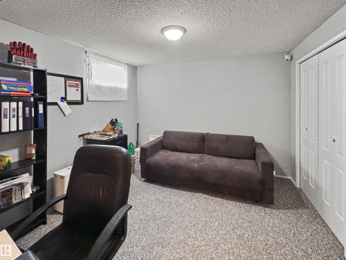 Carpeted office space featuring a textured ceiling - 4602 42 Avenue, Bonnyville Town, AB - Indoor Photo Showing Office