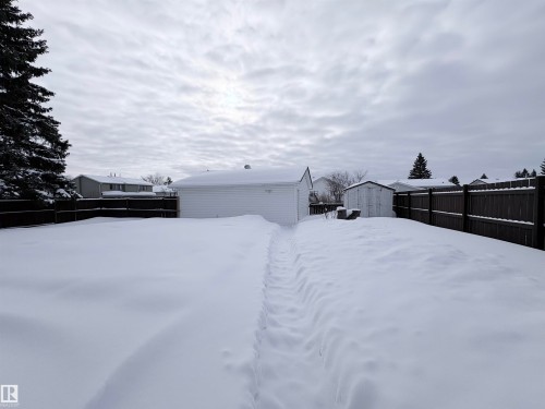 Yard layered in snow featuring a fenced backyard and an outbuilding - 4602 42 Avenue, Bonnyville Town, AB - Outdoor