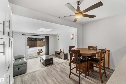 Dining space featuring light wood-style floors, a ceiling fan, and a skylight - 11615 150 Avenue, Edmonton, AB - Indoor Photo Showing Other Room