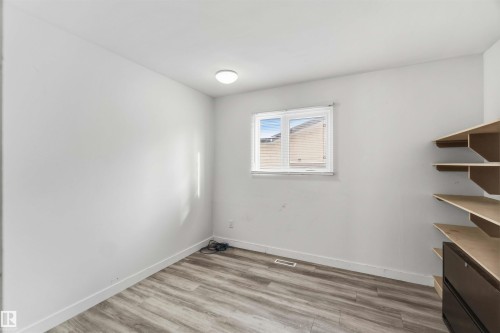Unfurnished room with light wood-style flooring and baseboards - 11615 150 Avenue, Edmonton, AB - Indoor Photo Showing Other Room