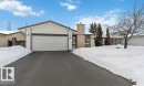 View of front of home with a chimney, an attached garage, and driveway - 11615 150 Avenue, Edmonton, AB  - Outdoor 