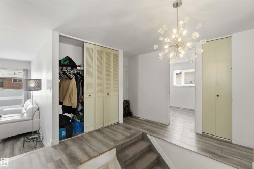 Stairs with wood finished floors and suspended lighting - 11615 150 Avenue, Edmonton, AB - Indoor Photo Showing Other Room
