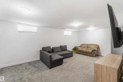 Living room with light colored carpet and baseboards - 11615 150 Avenue, Edmonton, AB - Indoor