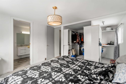 Bedroom featuring ensuite bathroom, a closet, and light carpet - 11615 150 Avenue, Edmonton, AB - Indoor Photo Showing Bedroom