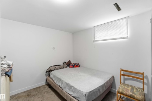Bedroom with light colored carpet and baseboards - 11615 150 Avenue, Edmonton, AB - Indoor Photo Showing Bedroom