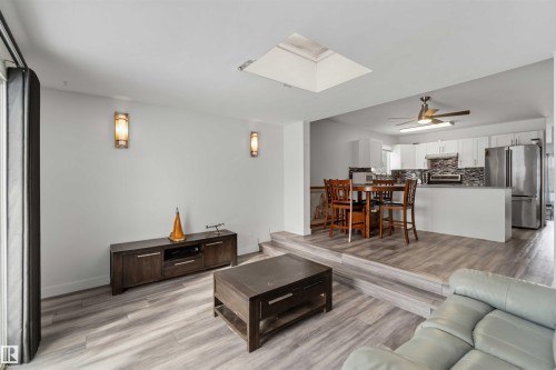 Living room with light wood finished floors, a skylight, and ceiling fan - 11615 150 Avenue, Edmonton, AB - Indoor Photo Showing Living Room