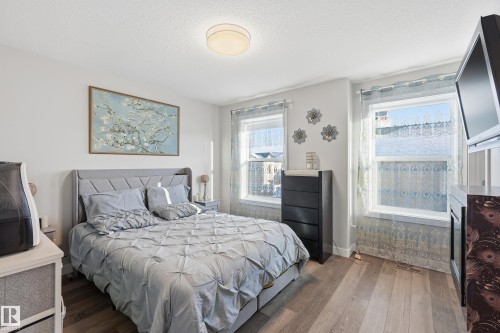 Bedroom featuring hardwood / wood-style floors and a textured ceiling - 7803 Yorke Road, Edmonton, AB - Indoor Photo Showing Bedroom