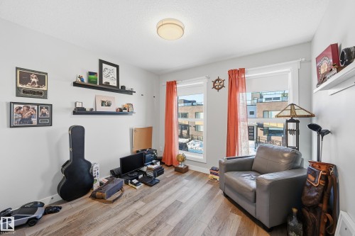 Sitting room with wood finished floors and a textured ceiling - 7803 Yorke Road, Edmonton, AB - Indoor