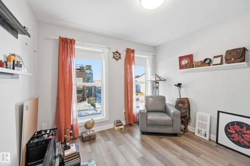 Living area featuring light wood-style flooring and a textured ceiling - 7803 Yorke Road, Edmonton, AB - Indoor