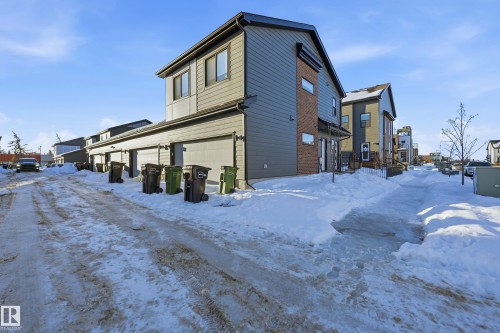 View of snow covered exterior featuring a garage and a residential view - 7803 Yorke Road, Edmonton, AB - Outdoor