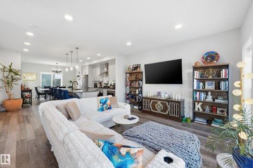 Living room with wood finished floors, a chandelier, and recessed lighting - 7803 Yorke Road, Edmonton, AB - Indoor Photo Showing Living Room