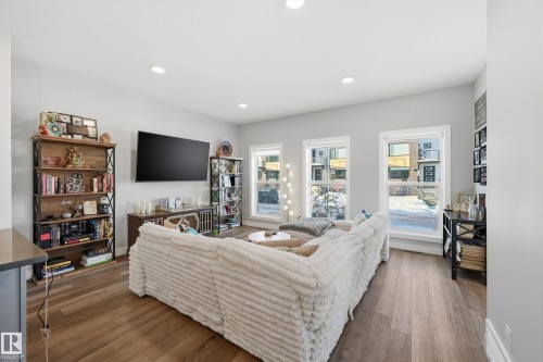 Living room with dark wood finished floors and recessed lighting - 7803 Yorke Road, Edmonton, AB - Indoor