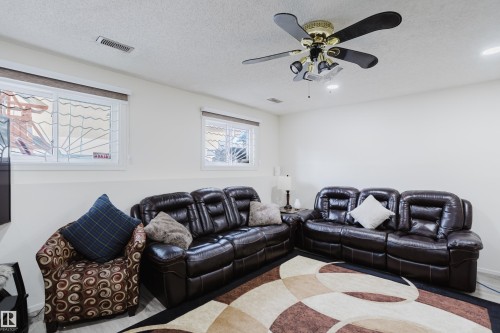 Living room with a ceiling fan and a textured ceiling - 236 Lago Lindo Crescent, Edmonton, AB 