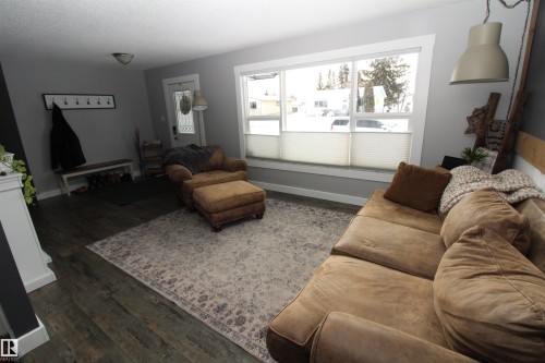 Living room featuring baseboards and dark wood finished floors - 10319 106 Ave, Westlock, AB - Indoor Photo Showing Living Room