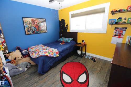 Bedroom with hardwood / wood-style flooring and ceiling fan - 10319 106 Ave, Westlock, AB - Indoor Photo Showing Bedroom