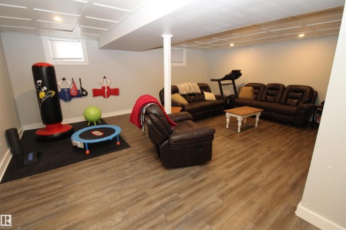 Living area with wood finished floors and recessed lighting - 10319 106 Ave, Westlock, AB - Indoor Photo Showing Basement