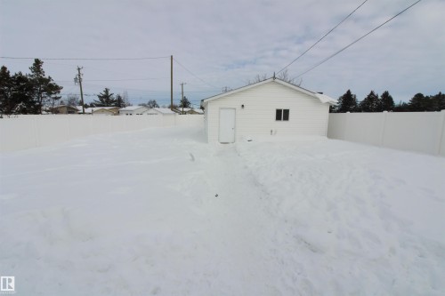 Snowy yard featuring a fenced backyard - 10319 106 Ave, Westlock, AB - Outdoor