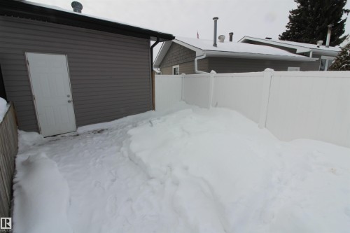 View of snowy exterior with a fenced backyard - 10319 106 Ave, Westlock, AB - Outdoor With Exterior