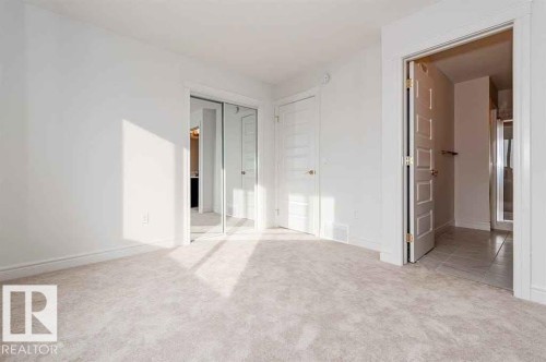 Unfurnished bedroom with light colored carpet and a closet - 10 446 Allard Boulevard, Edmonton, AB - Indoor Photo Showing Other Room