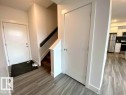 Entrance foyer with light wood-type flooring and stairs - 10 446 Allard Boulevard, Edmonton, AB  - Indoor Photo Showing Other Room 
