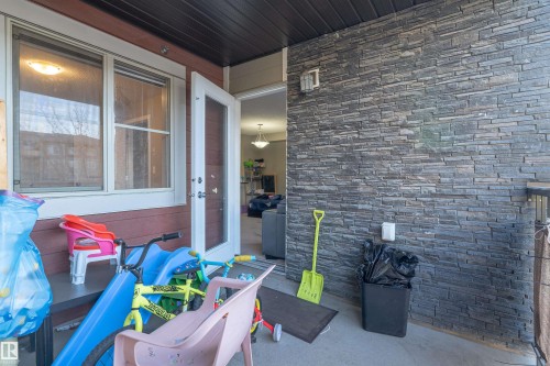 Entrance to property featuring a patio and stone siding - 206 3207 James Mowatt Trail, Edmonton, AB - Outdoor With Exterior
