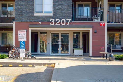 Doorway to property with stone siding - 206 3207 James Mowatt Trail, Edmonton, AB - Outdoor With Balcony With Facade