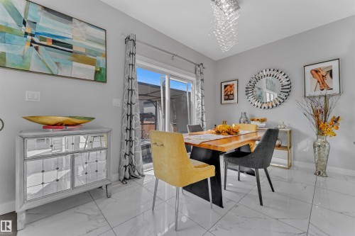 Dining room featuring hanging lights and light marble finish flooring - 3607 46 Avenue, Beaumont, AB - Indoor