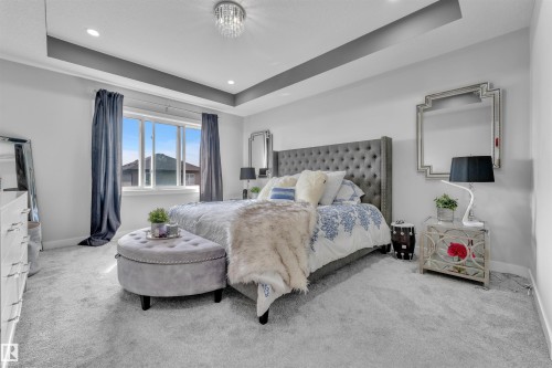 Bedroom with a raised ceiling, carpet flooring, and recessed lighting - 3607 46 Avenue, Beaumont, AB - Indoor Photo Showing Bedroom