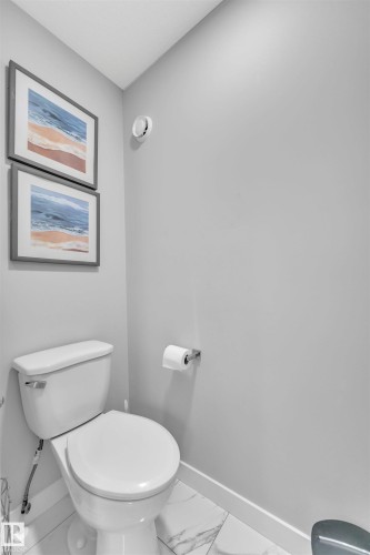 Bathroom featuring toilet and marble finish flooring - 3607 46 Avenue, Beaumont, AB - Indoor Photo Showing Bathroom