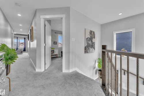Hallway with light colored carpet, recessed lighting, and an upstairs landing - 3607 46 Avenue, Beaumont, AB - Indoor Photo Showing Other Room