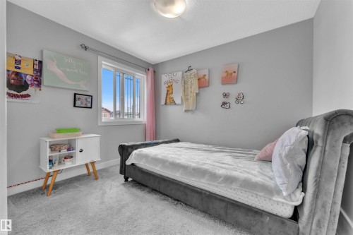 Bedroom featuring carpet floors and baseboards - 3607 46 Avenue, Beaumont, AB - Indoor Photo Showing Bedroom