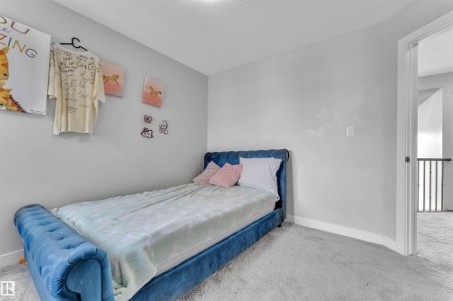 Carpeted bedroom featuring baseboards - 3607 46 Avenue, Beaumont, AB - Indoor Photo Showing Bedroom