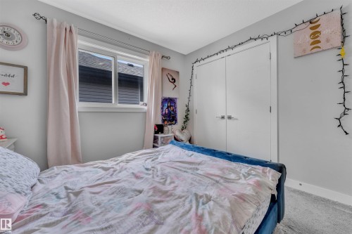 Carpeted bedroom with a closet and baseboards - 3607 46 Avenue, Beaumont, AB - Indoor Photo Showing Bedroom