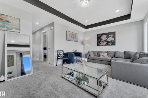 Carpeted living room with recessed lighting and a raised ceiling - 3607 46 Avenue, Beaumont, AB - Indoor Photo Showing Living Room