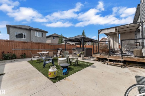 Fenced backyard featuring a patio area, a gazebo, a hot tub, and outdoor dining area - 3607 46 Avenue, Beaumont, AB - Outdoor With Deck Patio Veranda