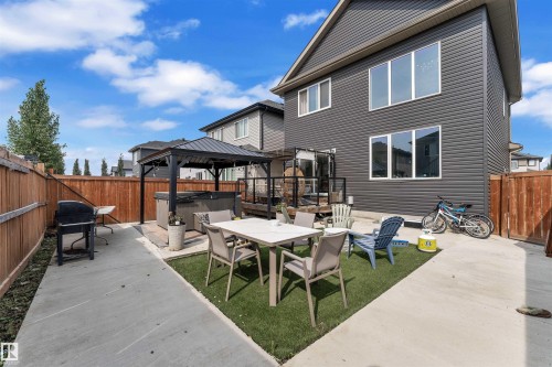 Fenced backyard featuring a patio, a gazebo, a hot tub, outdoor dining space, and area for grilling - 3607 46 Avenue, Beaumont, AB - Outdoor With Deck Patio Veranda With Exterior