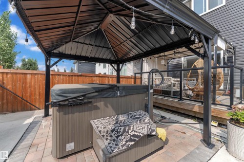 View of patio with a hot tub, a gazebo, and a deck - 3607 46 Avenue, Beaumont, AB - Outdoor With Exterior
