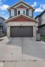 Craftsman-style home featuring stone siding, concrete driveway, and a garage - 3607 46 Avenue, Beaumont, AB  - Outdoor 